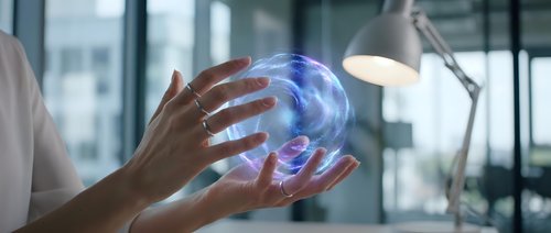 Professional woman holding glowing digital brain hologram in modern office environment representing artificial intelligence and future technology innovation.