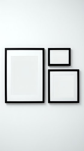 Three black picture frames with white mats arranged on a light wall, gallery wall mockup for art prints and poster display.