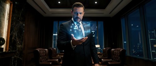 Professional businessman in elegant suit using holographic technology interface in luxury office with city skyline view at night for corporate presentations.