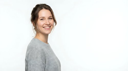 Smiling woman with brown hair wearing gray sweater, isolated on white background, suitable for portrait, lifestyle, and business design projects.