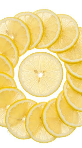 Fresh lemon slices arranged in a circle on white background, isolated. Bright yellow citrus fruit pattern for food, health, and summer designs.