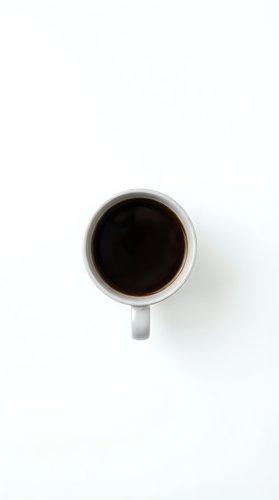 White coffee mug with black coffee viewed from above on clean white background for minimalist design projects.