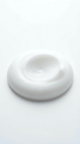 Creamy white swirl of moisturizer, lotion, or skincare product isolated on white background, ready for cosmetics, beauty, and wellness design projects.