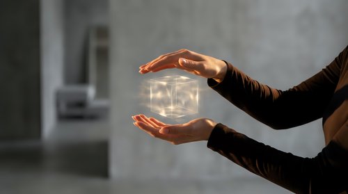 Hands holding glowing light bulb against blurred interior background, representing innovation, ideas, energy solutions, and sustainable business concepts for design projects.
