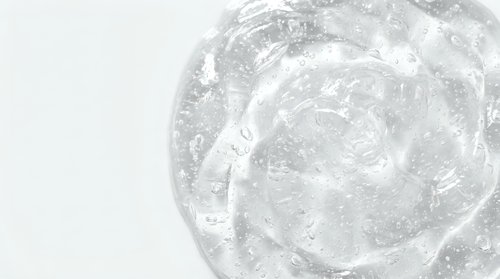 Transparent gel or serum swirl with bubbles and texture, isolated on white background for skincare, cosmetics, and beauty product design use.