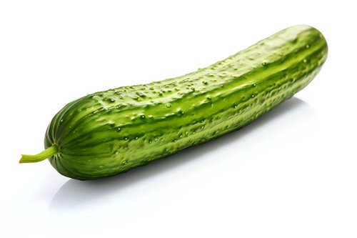 Fresh green cucumber with textured skin isolated on white background, ready for healthy eating and food design projects.