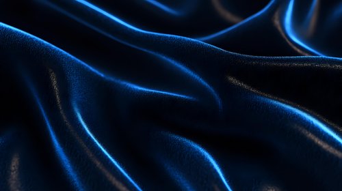 Luxurious dark blue silk fabric with elegant folds and waves creating dramatic light effects and glossy reflections. Smooth textile background for luxury designs.