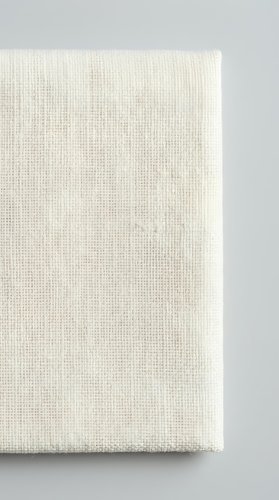 Natural linen canvas texture with woven fabric pattern on neutral background for artistic projects and craft applications.