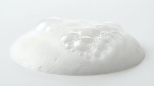Clear transparent gel blob with bubbles isolated on white background for skincare cosmetic product design and beauty applications.