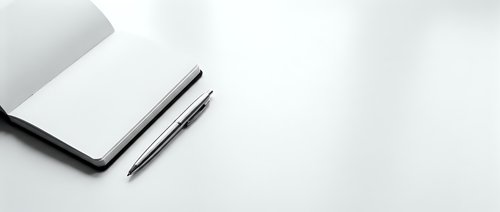 Minimalist workspace with closed laptop and black pen on clean white surface for business and productivity concepts.