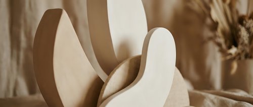 Modern abstract wooden sculpture with curved flowing forms in warm beige tones, contemporary art piece for minimalist interior design and home decor.
