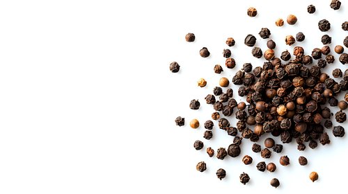 Black peppercorns scattered on white background, aromatic whole spices isolated with natural shadows, ready for culinary and design projects.