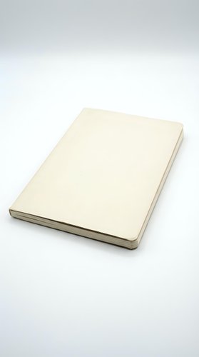 Closed cream colored notebook with blank cover isolated on white background for mockup design and branding projects.