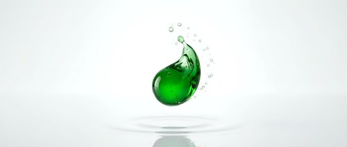Green liquid splash creating dynamic wave motion with droplets against clean white background for product photography and advertising campaigns.