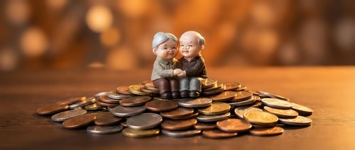 Elderly couple figurines sitting on pile of coins representing retirement savings, financial planning and pension fund security with warm bokeh background.