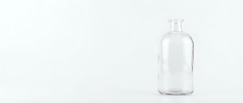 Clear glass bottle with white cap isolated on white background for product mockup and packaging design projects.