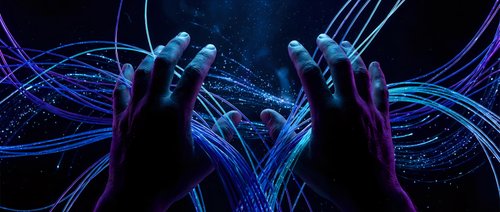 Human hands manipulating glowing blue digital energy streams and light trails in futuristic cyberspace environment for technology concepts.