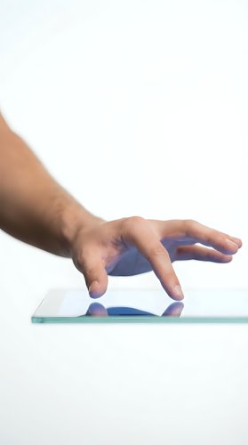 Male hand with medium skin tone touching glass surface against white background, representing technology interaction, digital interface, and modern communication for web and app design.