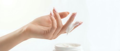 Female hand with manicured nails in open palm gesture against white background, suitable for healthcare, wellness, skincare and beauty product advertising.