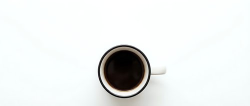 White coffee cup with black coffee viewed from above on clean white background isolated for design projects and commercial use.