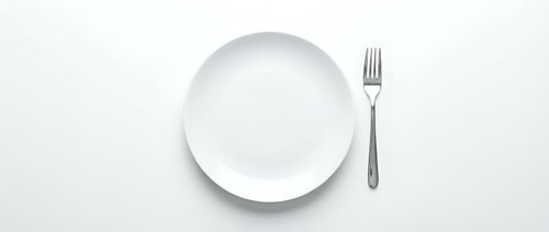 Empty white plate with fork on white background, isolated for restaurant menu design, dining concepts, and food service layouts.