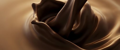 Smooth melted chocolate swirling in rich brown waves creating luxurious texture for culinary dessert and confectionery advertising applications.