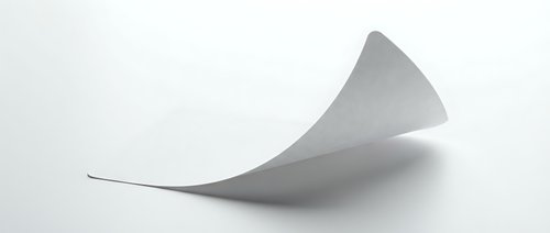 Curved white paper sheet floating with elegant wave motion against clean background for modern design projects and creative presentations.