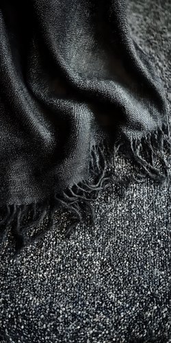 Abstract black and silver textured background with flowing liquid-like patterns and granular surface details creating dramatic contrast and depth for luxury designs.