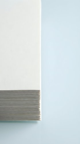 Stack of white paper sheets with clean edges on neutral background for office supplies and business documentation concepts.