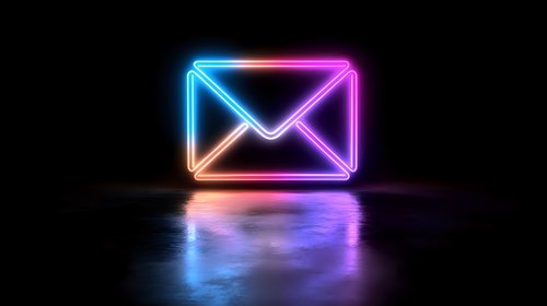 Glowing neon mail envelope icon with colorful blue and pink gradient light effect on dark background with reflection on glossy surface.