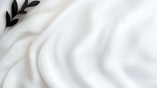 Elegant white silk fabric with black olive branch silhouette creates luxurious backdrop for wedding, spa, or cosmetic branding. Soft waves add graceful movement.