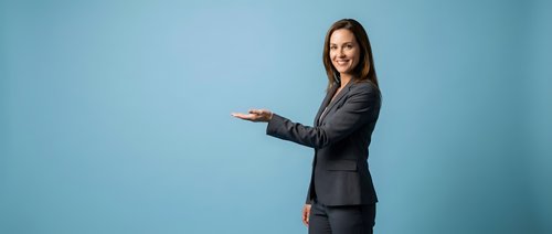 Professional businesswoman in dark suit presenting with open hand gesture on blue background for corporate marketing materials.