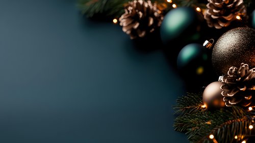 Festive corner arrangement with pine cones, metallic ornaments and evergreen branches against dark background creates moody holiday atmosphere.