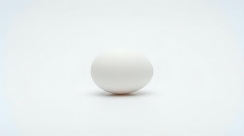 Single white chicken egg on clean white background isolated for cooking, baking, breakfast recipes and food photography projects.