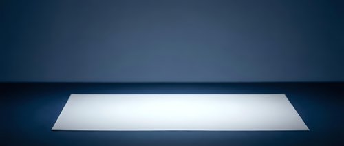 Illuminated white rectangular platform on dark blue background, ideal for product display and showcase presentations.
