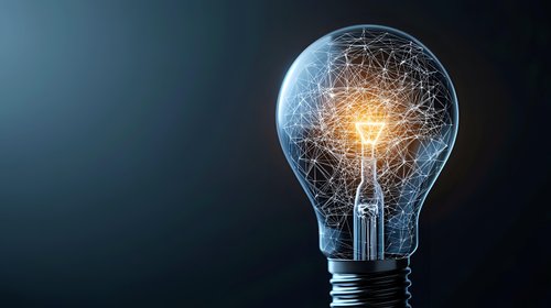 Glowing light bulb with illuminated neural network pattern inside against dark background symbolizing artificial intelligence and innovative technology.