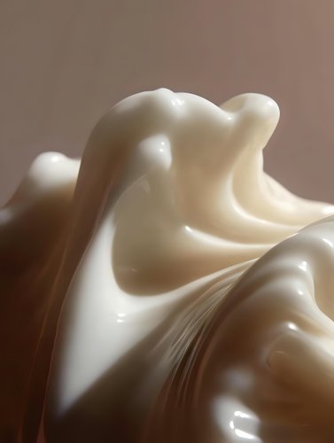 Smooth flowing curves of white cream or fabric create elegant abstract shapes against soft brown background, highlighting texture and gentle folds in minimalist style.